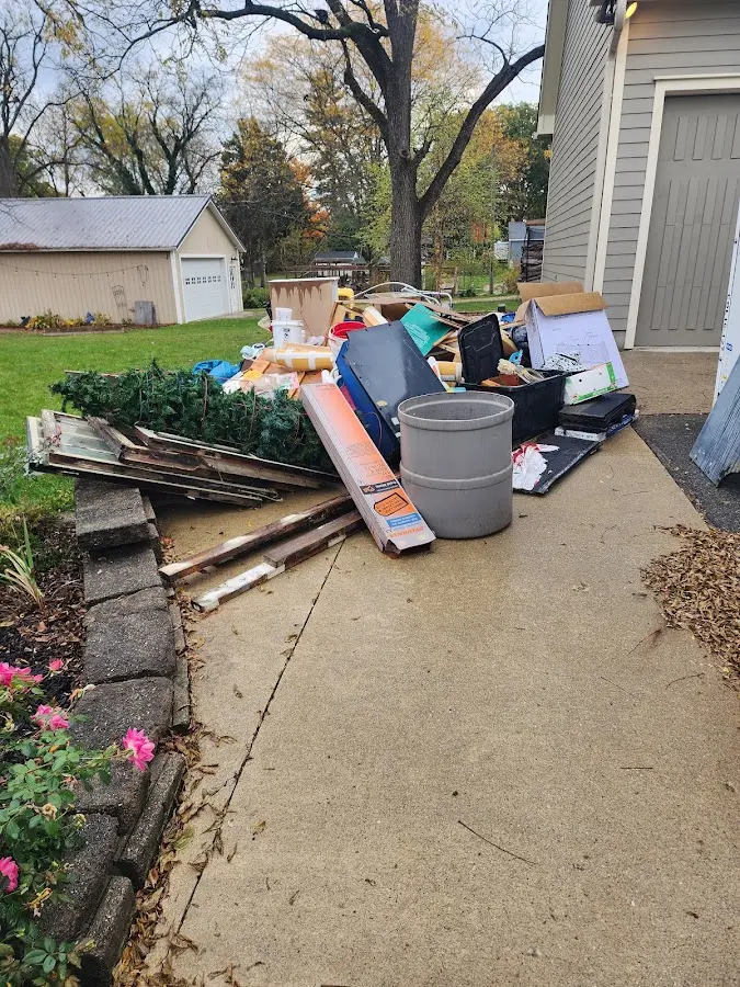 Dumpster being loaded with debris for 12 Yard Dumpster Rental in Tewksbury